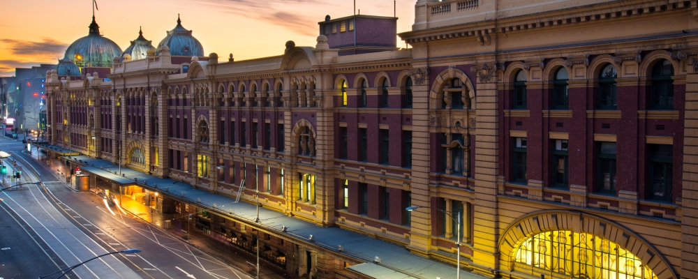 Flinders Street railway station is a railway station on the corner of Flinders and Swanston Streets in Melbourne, Australia. It serves the entire metropolitan rail network. Backing onto the city reach of the Yarra River in the heart of the city, the complex covers two whole city blocks and extends from Swanston Street to Queen Street.