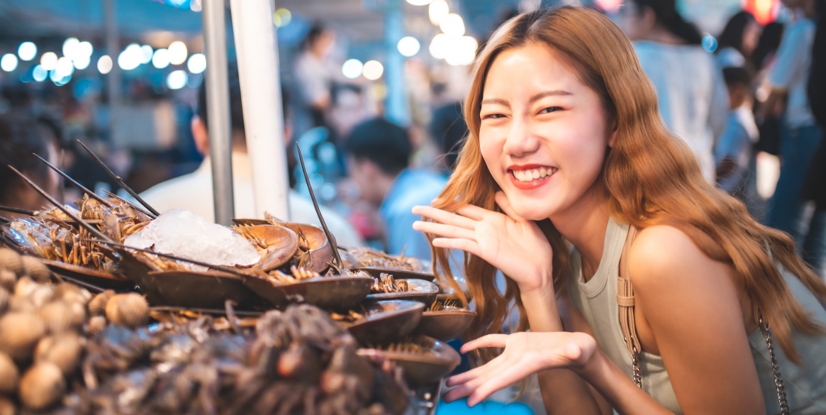 Woman Standing At street food Market Stall