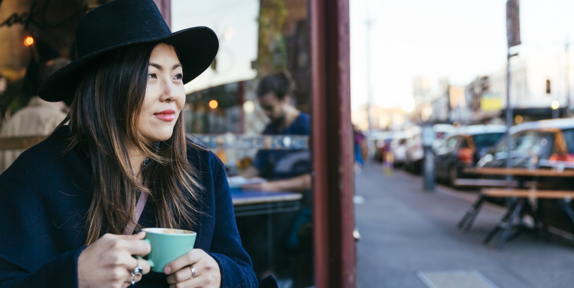 Woman with a hat taking a coffee in Fitzroy