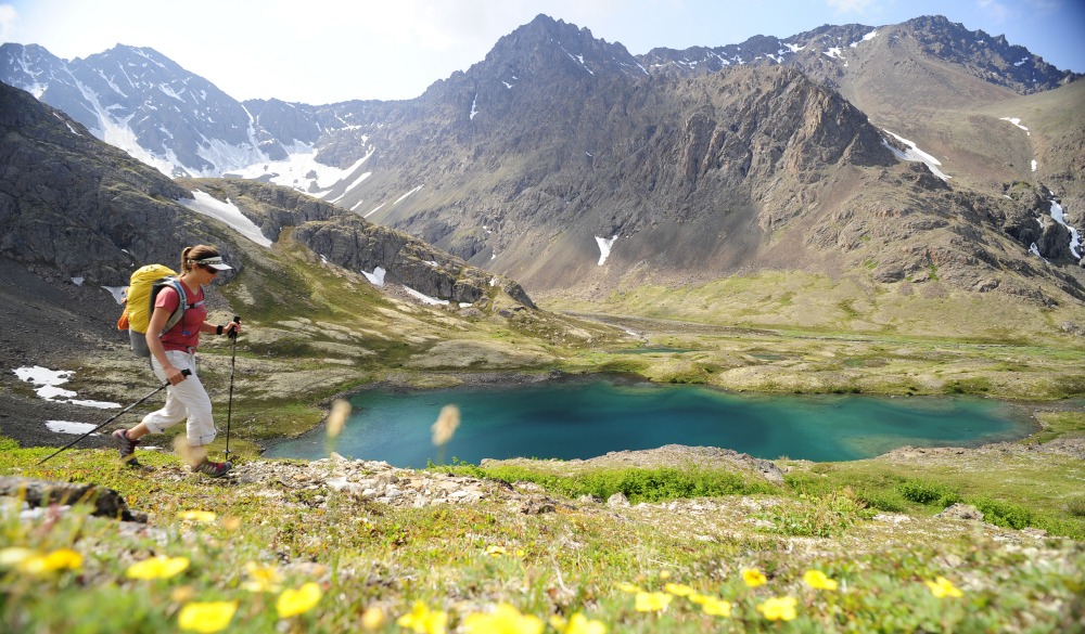 Backpacker hiking in Chugach State Park near Anchorage, Alaska, destination to avoid crowds