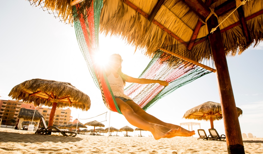 A woman swinging in a hammock while on vacation in Mexico.