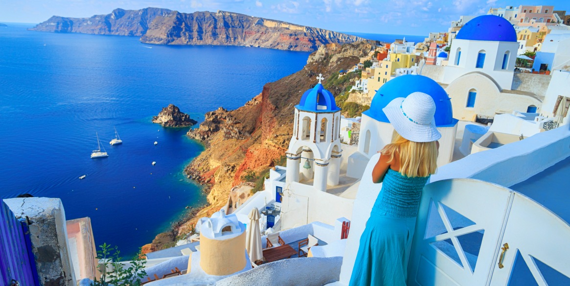 woman enjoying vacations in Santorini, Greece.