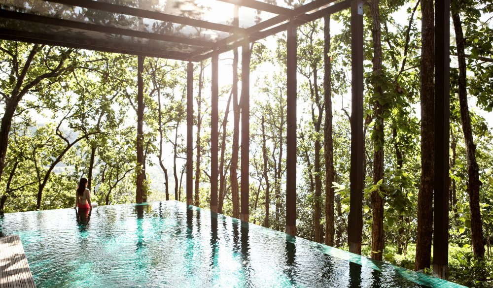 A woman wades in the pool of the Ganga Pool Villa at Ananda in the Himalayas, The Palace Estate, Narendra Nagar, Tehri Garhwal, Uttarakhand, India. The Ganga Pool Villa is a one-bedroom private villa with its own infinity pool.