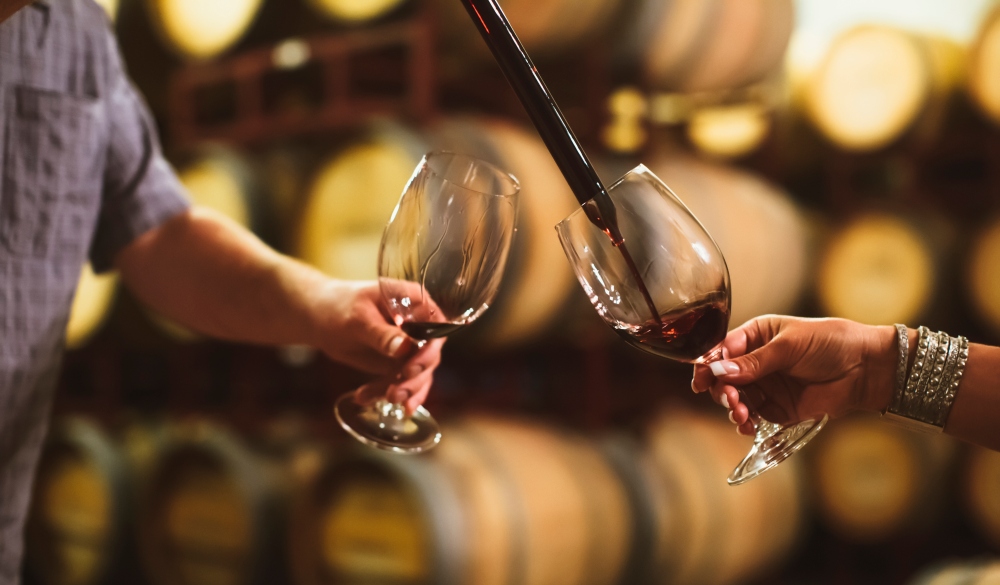 Caucasian couple tasting wine in cellar