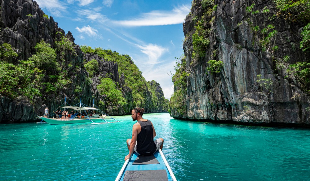 traveler sitting on boat deck,