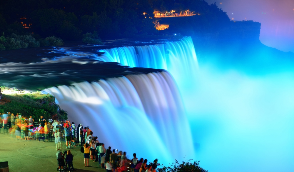 Niagara Falls lit at night by colorful lights