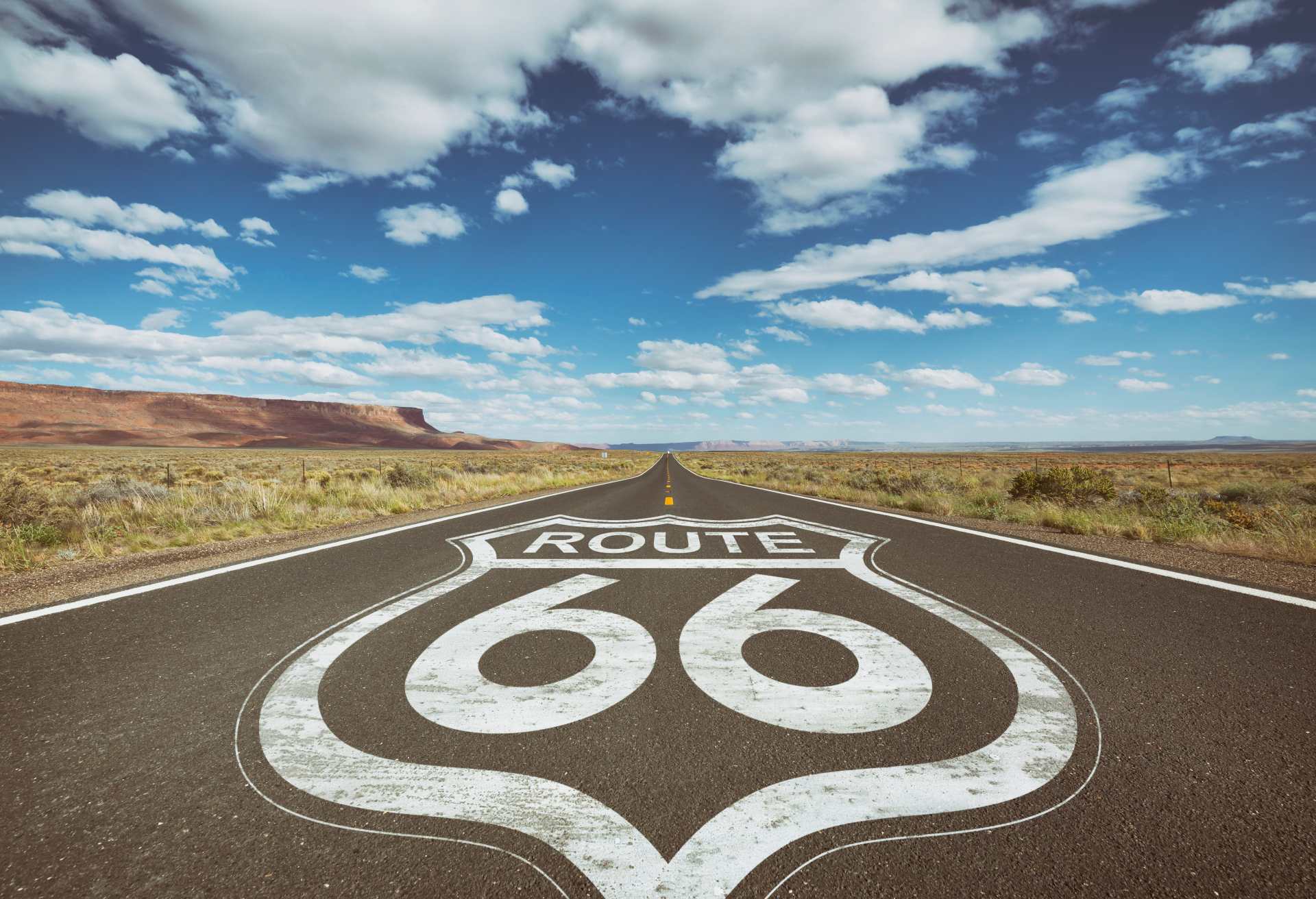 Highway sign for Route 66 on asphalt of country road