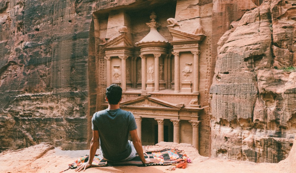 Man admiring the Treasury of Petra, ultimate travel bucket list
