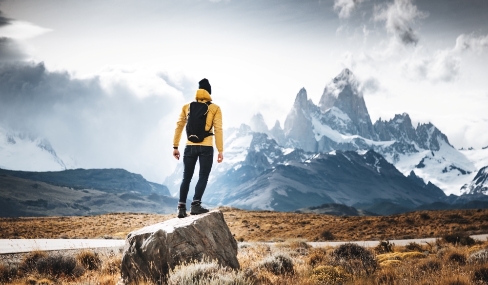 man resting on the rock in el chalten