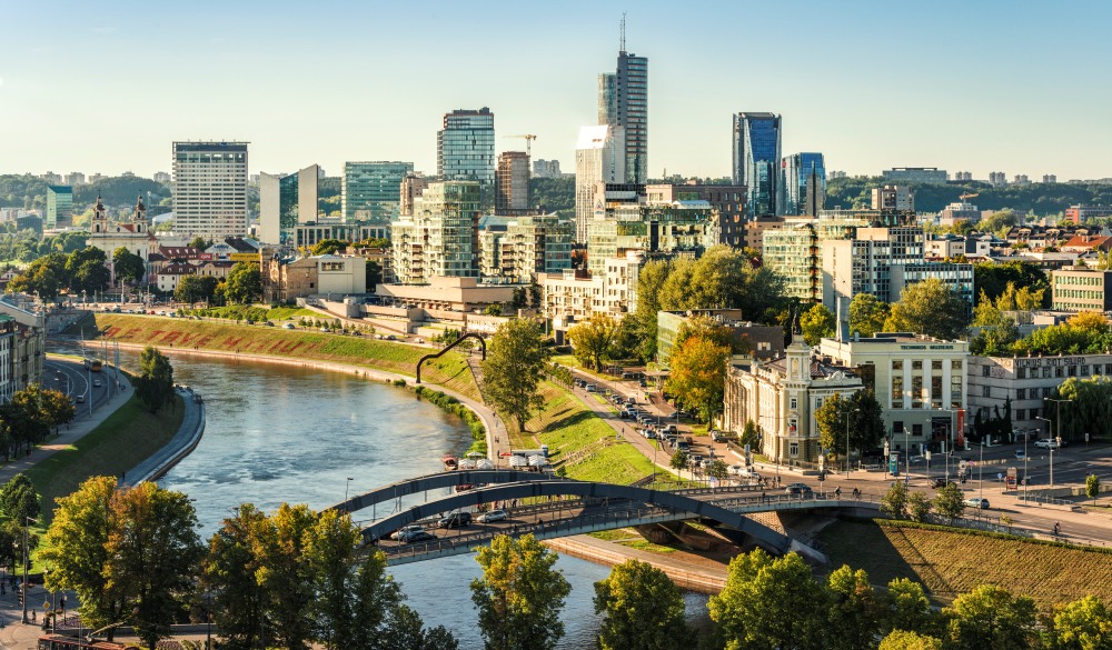 view to the modern city of Vilnius with Europa Tower and Neris River in the foreground, travel gems in europe