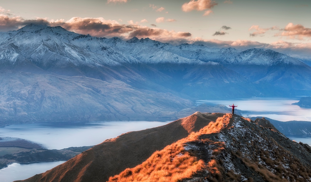 Man Standing On the Top of Mount Roy, south island road trip destination