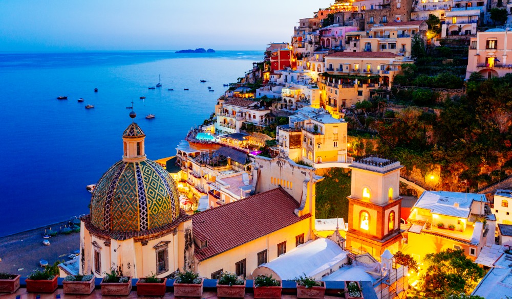 Positano, Amalfi Coast, Campania, Sorrento, Italy. View of the town and the seaside in a summer sunset