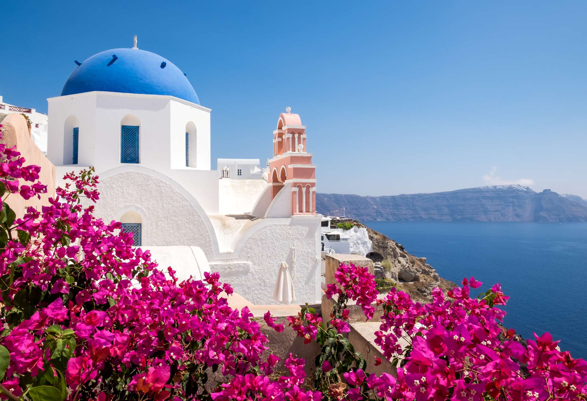 traditional cycladic houses with flowers in foreg