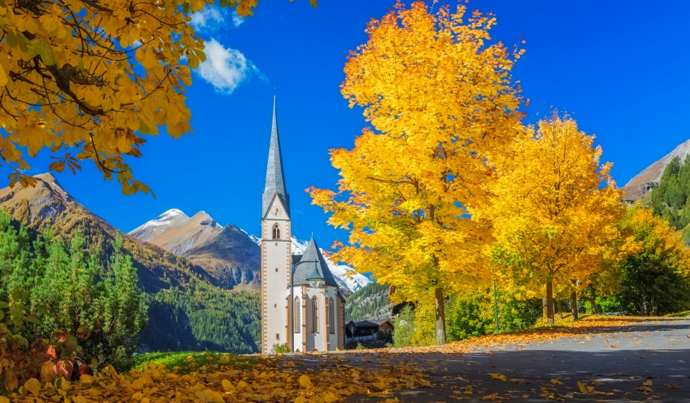 Heiligenblut Alpine village with beautiful pilgrimage church in autumn, destination for road trips in austria