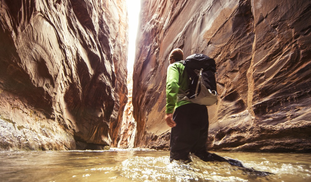 Hiking a slot canyon filled with water.