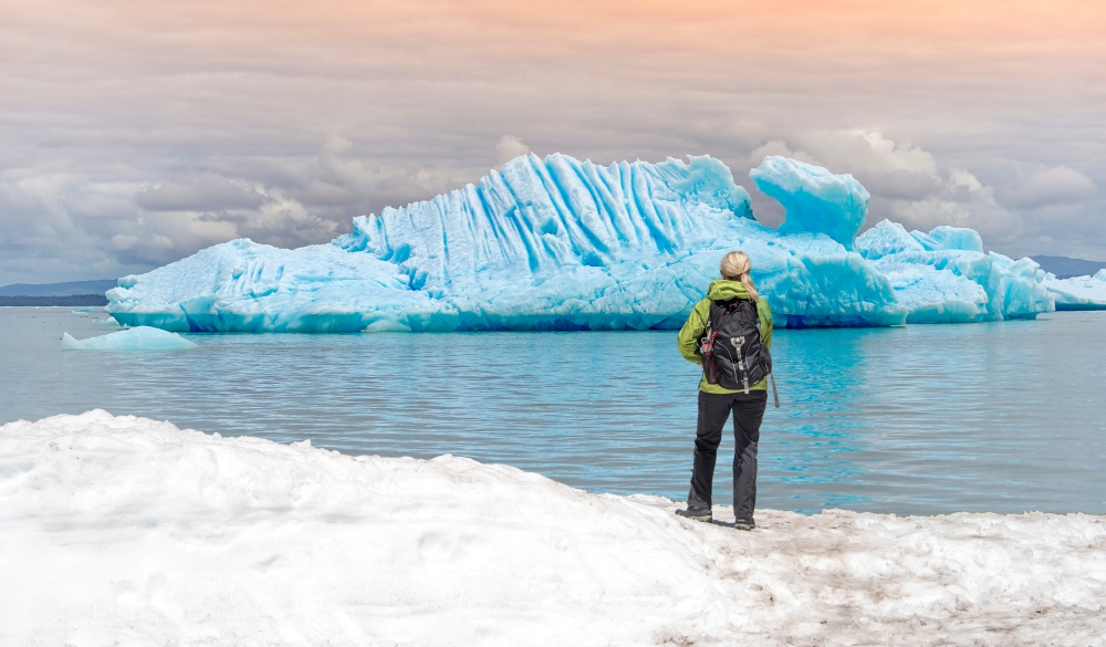 Woman Standing At Lake Against Sky During Winter