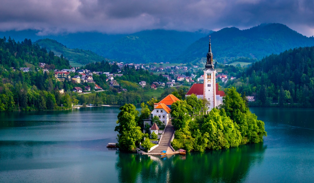 Beautiful view of Pilgrimage Church of the Assumption of Maria, famous Bled Island (Blejski otok), and scenic Bled Lake, with Julian Alps in the background, Slovenia, Europe.