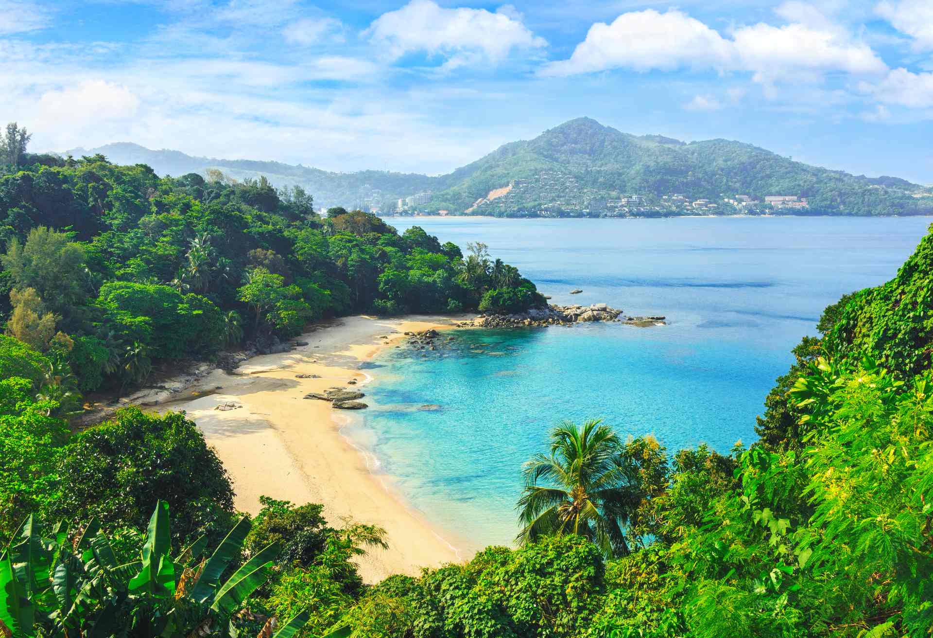 Picturesque view of Andaman sea in Phuket island, Thailand. View through the jungle on the beautiful bay and mountains. Tropical beach Laem Singh.