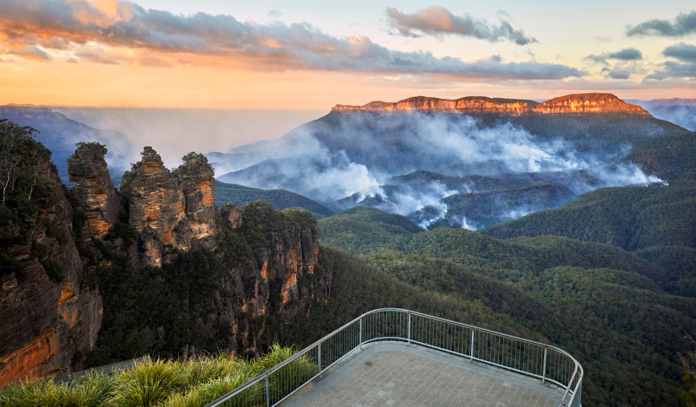 Three Sisters and Queen Elizabeth Lookout with no people and bushfire in the Jamison Valley, Blue Mountains National Park, romantic destinations in Australia