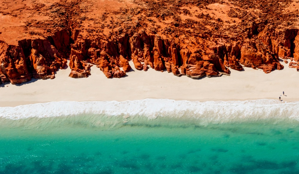 A helicopter view of the white sands, turquoise ocean and striking red Kooljaman Cliffs at Cape Leveque in Western Australia's north west.
