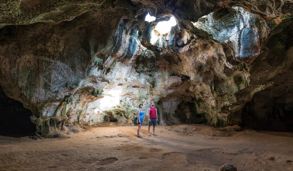 Couple discover beach passage and rock dome, destination fora crowd-free vacation