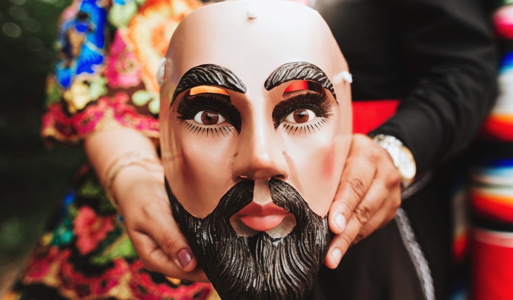 Midsection Of Woman Holding Mask, day of the dead celebration