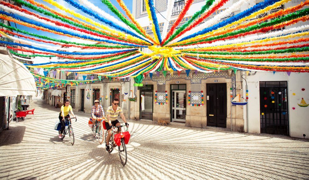 Three riders crossing village in their trip through Alentejo