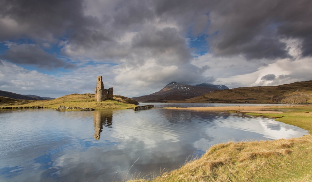 Ardvreck Castle reflected on the waters of Loch Assynt,