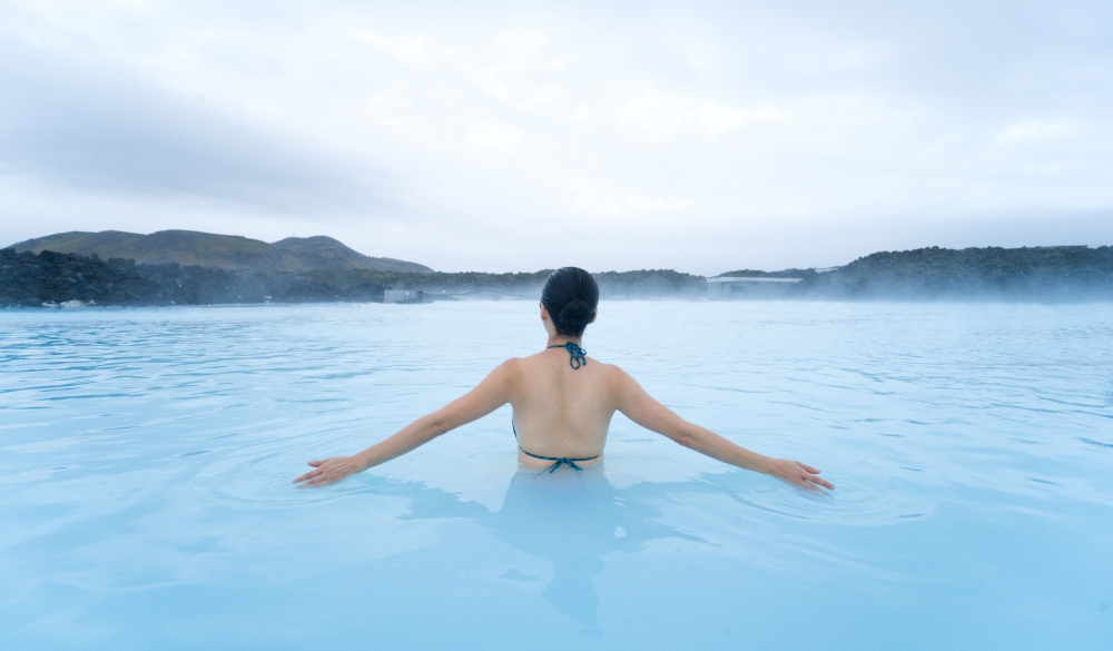 woman relaxing at the Blue Lagoon , destination for a weekend getaways in europe