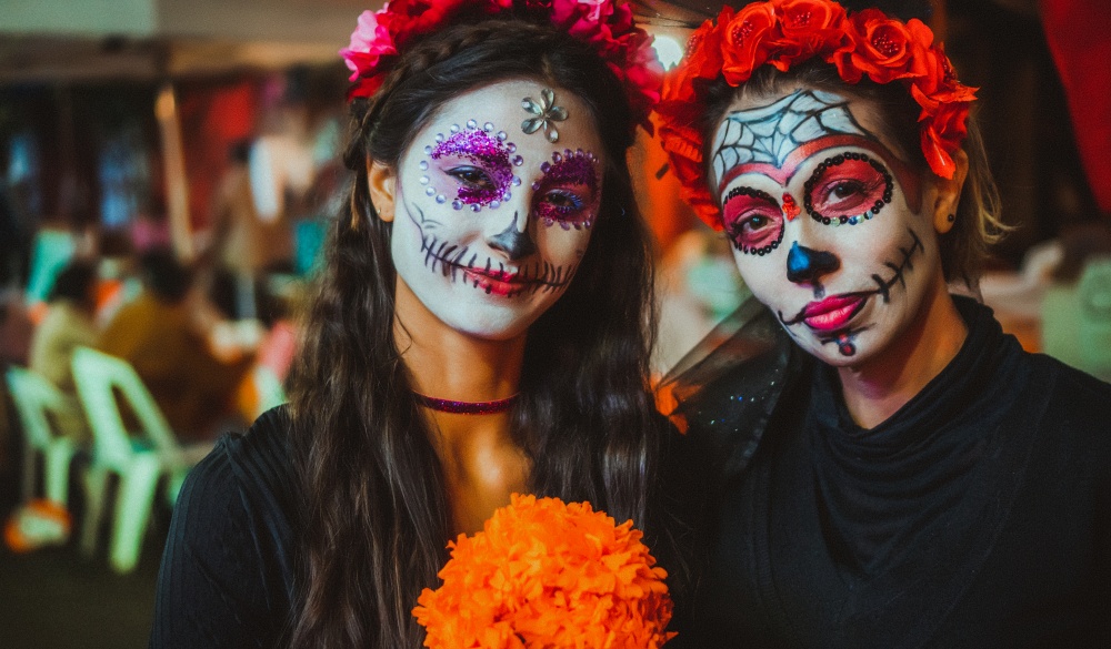 Portrait of a mother and daughter with traditional make up for the day of the dead celebration