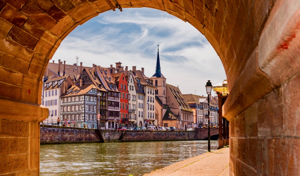 Buildings By Canal Seen Through Archway 