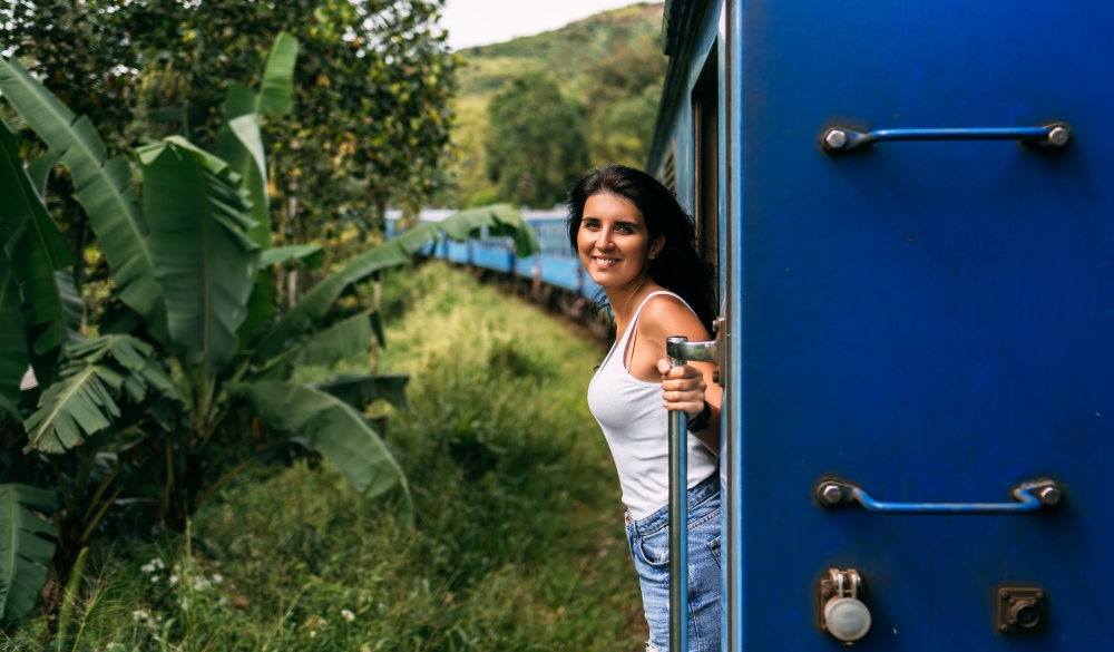 Beautiful Girl Traveling By Train Among Mountains