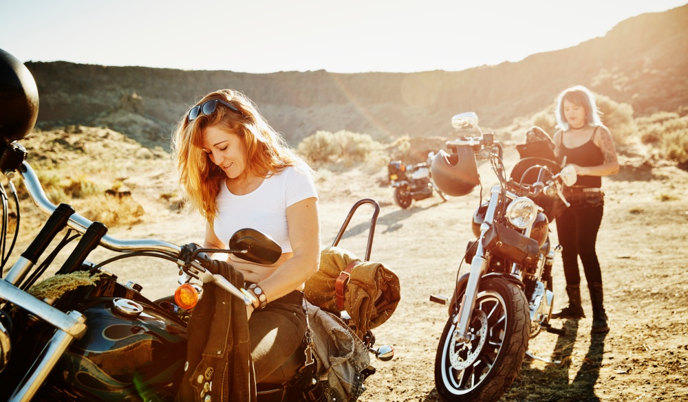 Motorcyclists on road trip preparing to ride