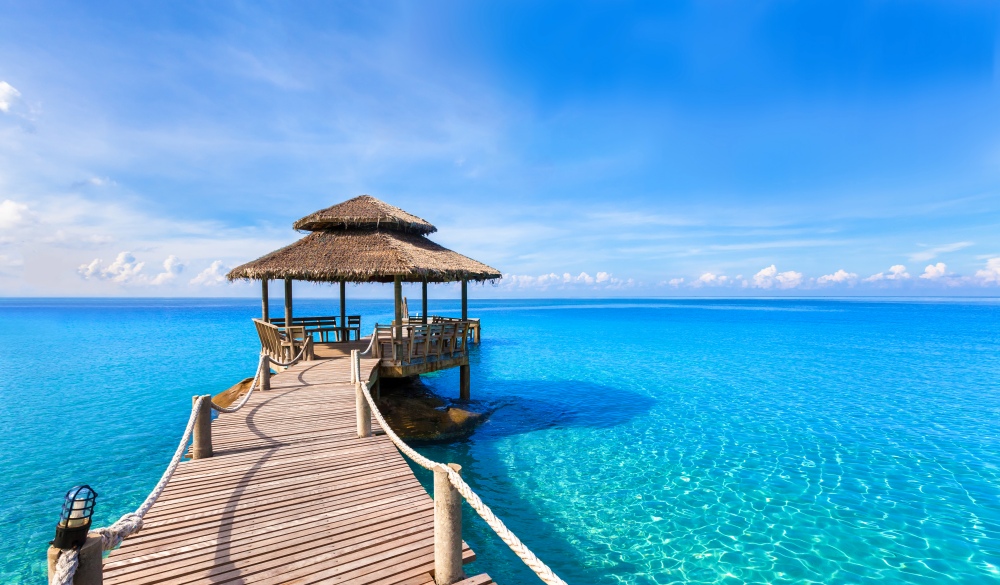 Beautiful summer tropical beach landscape, wooden pier, turquoise sea water