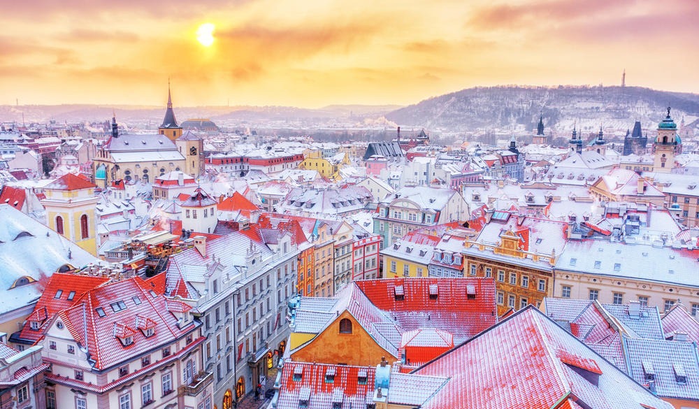 Prague, classical view of snowy roofs, city center. Winter scene.