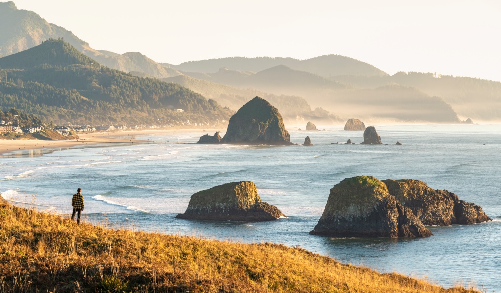 Man looking at view, Ecola State Park, Cannon Beach, Oregon, USA.