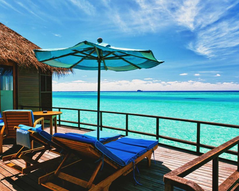 Overwater villa balcony overlooking tropical lagoon