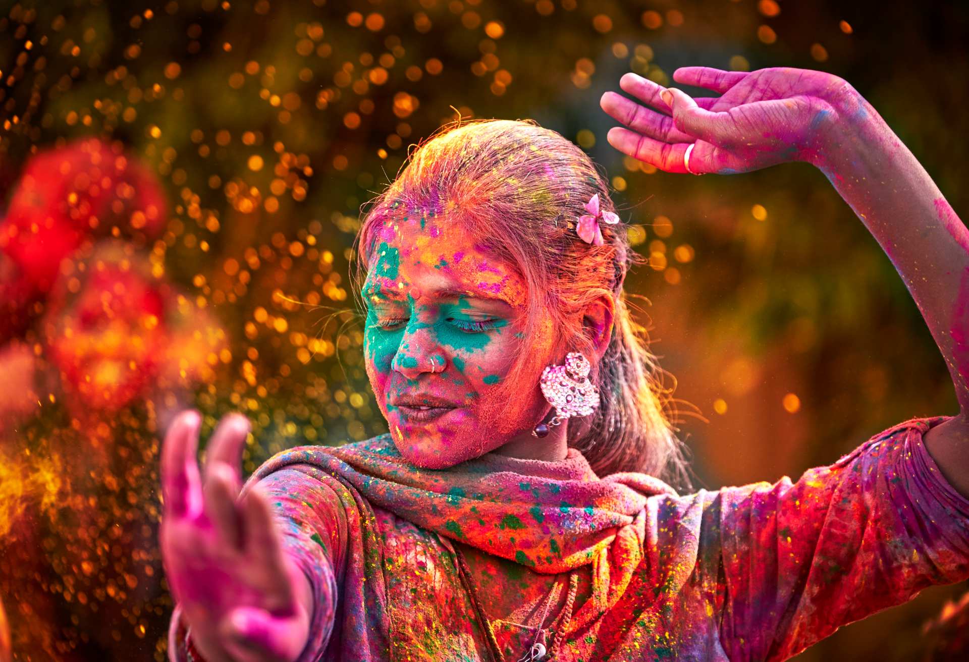 Portrait Of Indian Woman With Colored Face Dancing During Holi