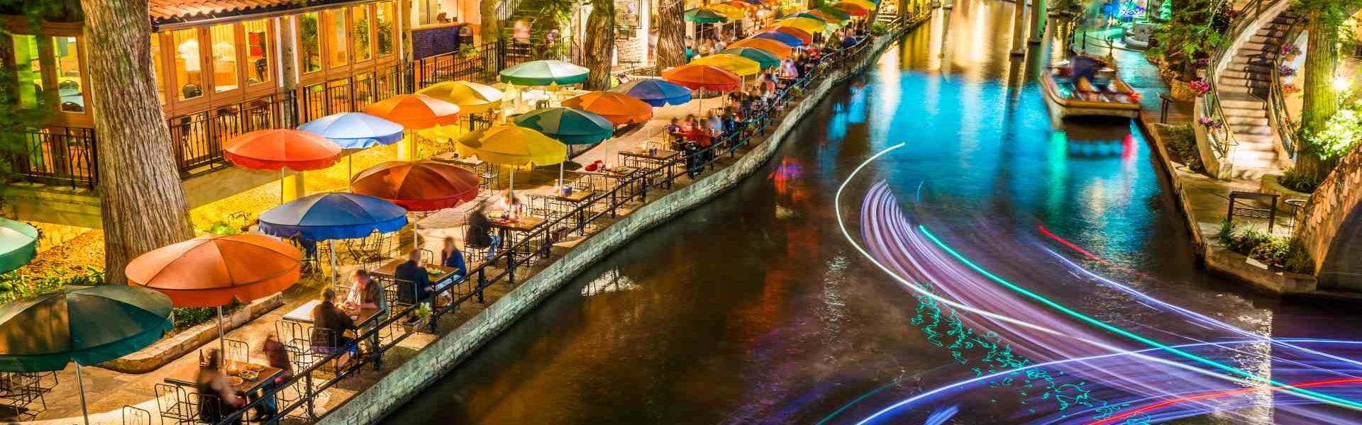 San Antonio Riverwalk, Texas, scenic river canal tourism umbrellas night