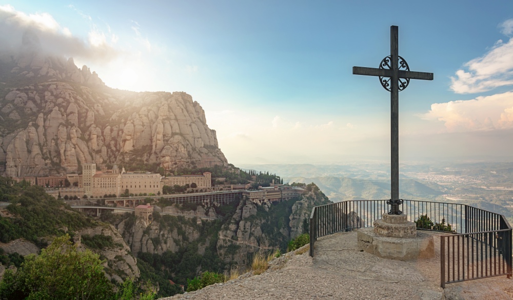 Christian cross from Montserrat Mountain viewpoint at sunset