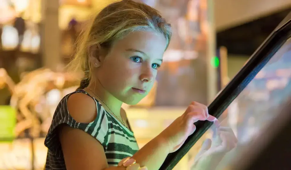 Caucasian girl using touch screen