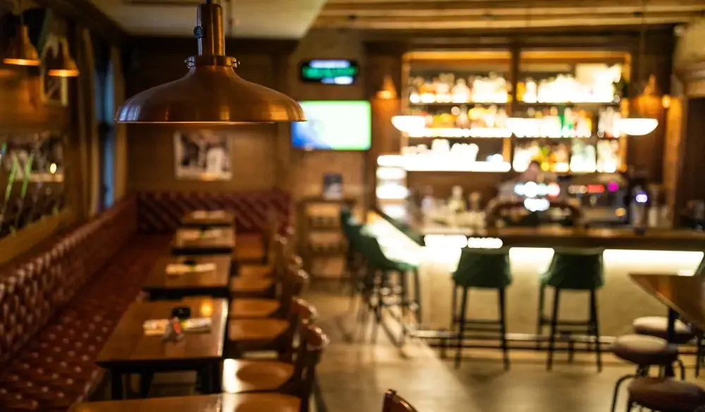Interior of wooden retro pub with chairs, tables and other furniture, without people