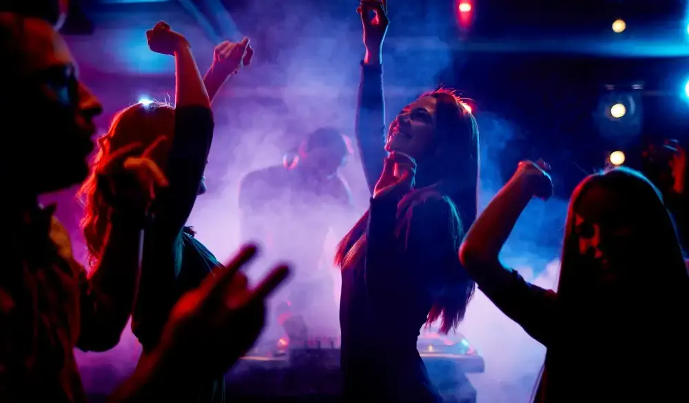Group of dancing young people enjoying night in club; Shutterstock ID 247679890