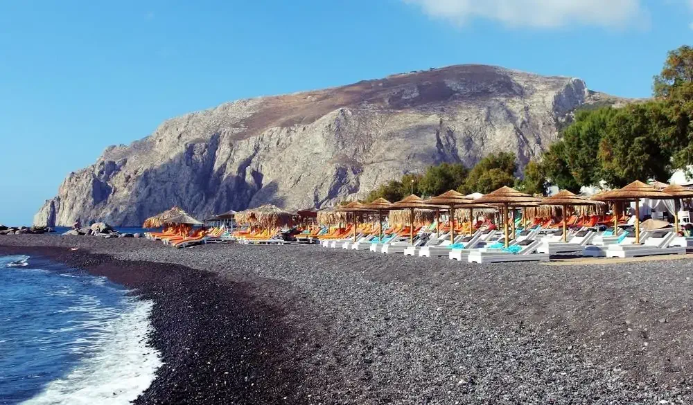 beach in Kamari town on Santorini island, Greece; Shutterstock ID 695234206