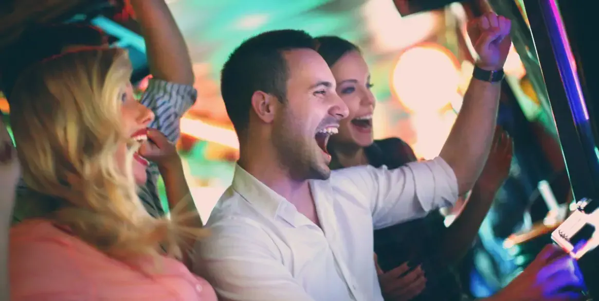 Group of young adults in mid 20's playing slots in a casino