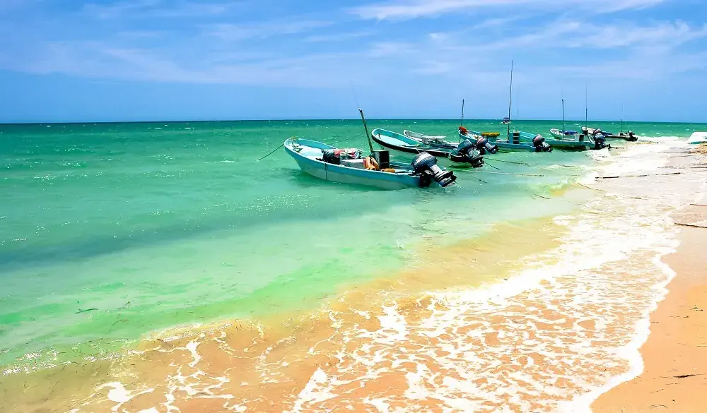 Rural Yucatan Peninsula beach photo showing some old boats used for fishing