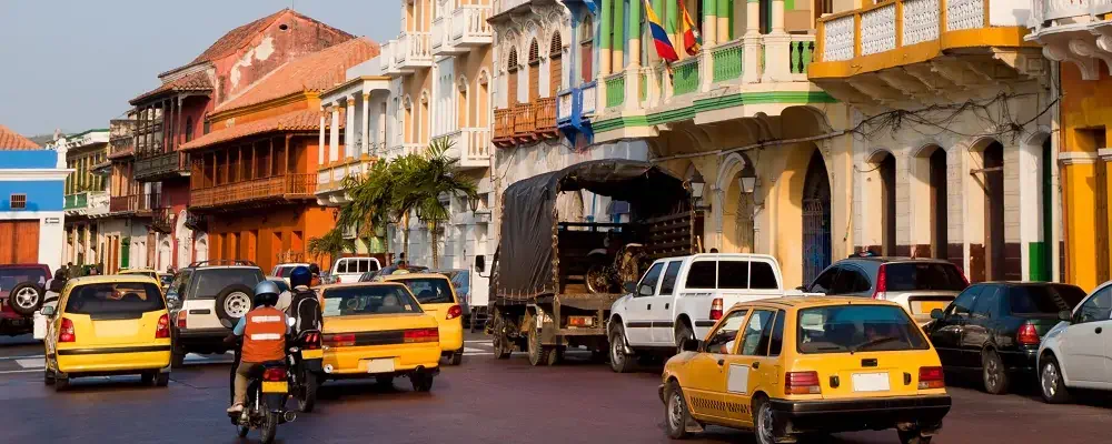 Busy street in the Getsemani district of Cartagena Colombia - this area is known for its colourful buildings and budget accommodation.