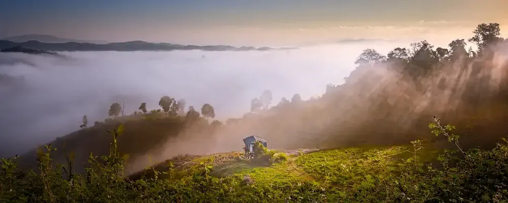 landscape of the countryside of northern of Thailand, hut in the mist flowing of the of in mountain between the hills in the morning with light beam along the scenic