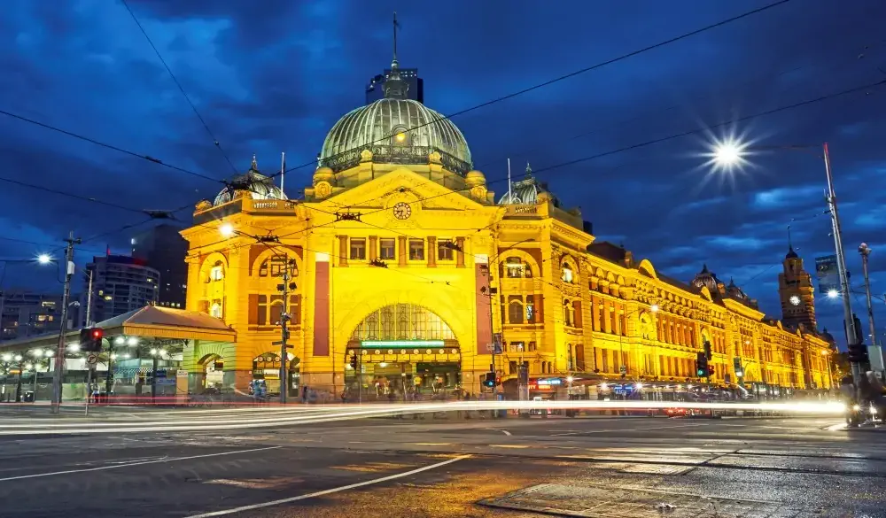 Facade of Flinders street station illuminated at night in Melbourne