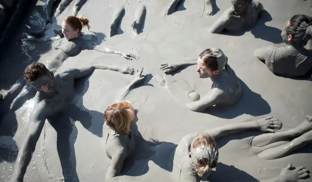 Group of friends swimming in El Totumo mud volcano in Cartagena, Colombia